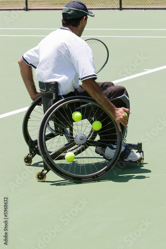 A wheelchair bound athlete on the tennis court