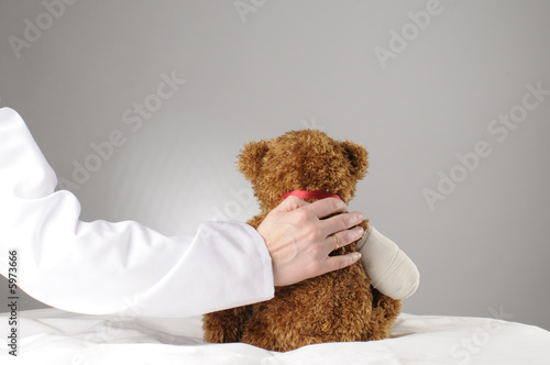 an injured teddy getting comfort by a doctor