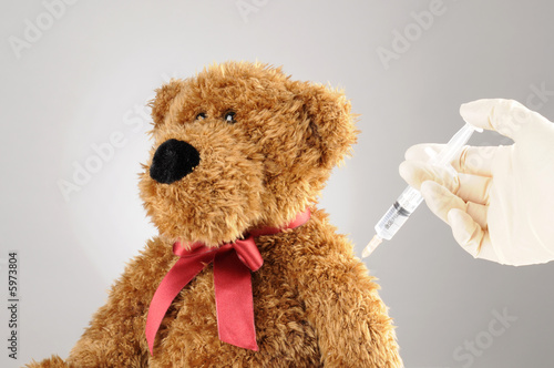 a teddy bear is getting an injection