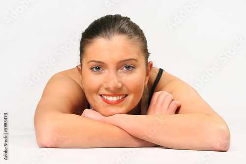 young woman is lying over white background