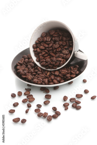 The black cup with fragrant coffee costs on a table
