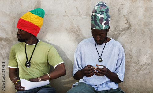 Rastafarian men smoking cannabis photo