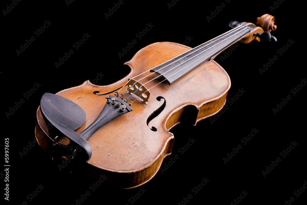 Fototapeta premium old violin close-up isolated on black background