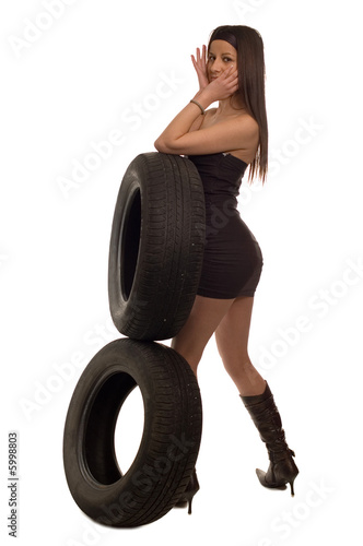 Young sexy girl holding a car wheel photo