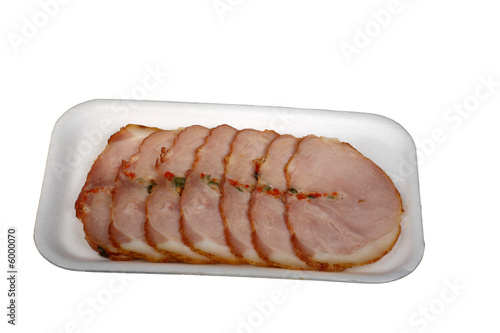Slices of a ham with spices isolated on a white background