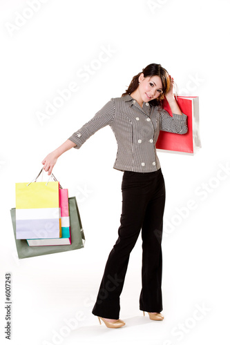 young woman happily shopping full of paper bags