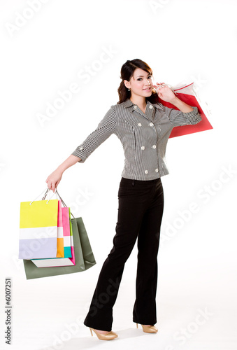 young woman happily shopping full of paper bags