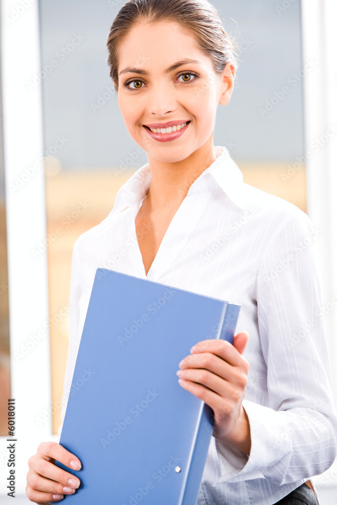 Image of nice executive secretary holding a working folder Image of nice executive secretary holding a working folder