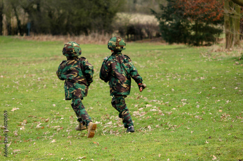 two boys running in army gear