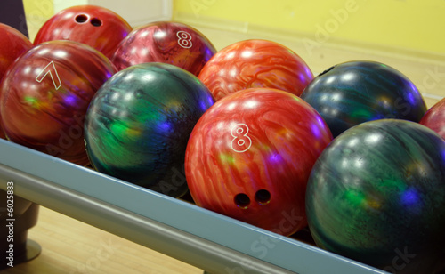 several multicolored balls for playing bowling.