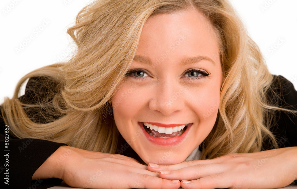 Smiling Blonde Woman Laying on her Desk Smiling Blonde Woman Laying on her Desk