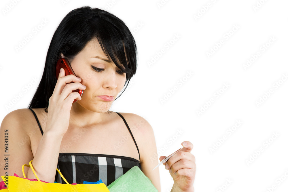 A shopping woman calling her credit card company A shopping woman calling her credit card company