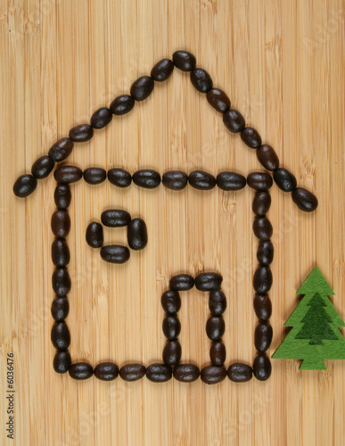 Coffee beans on wooden background. Home and tree.