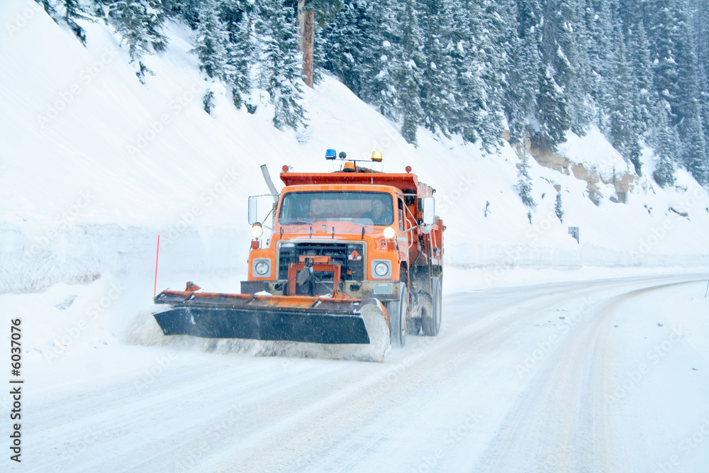 Fototapeta premium Snow plow removing snow from mountain highway
