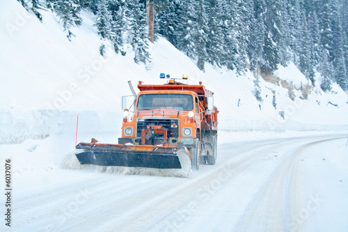Snow plow removing snow from mountain highway