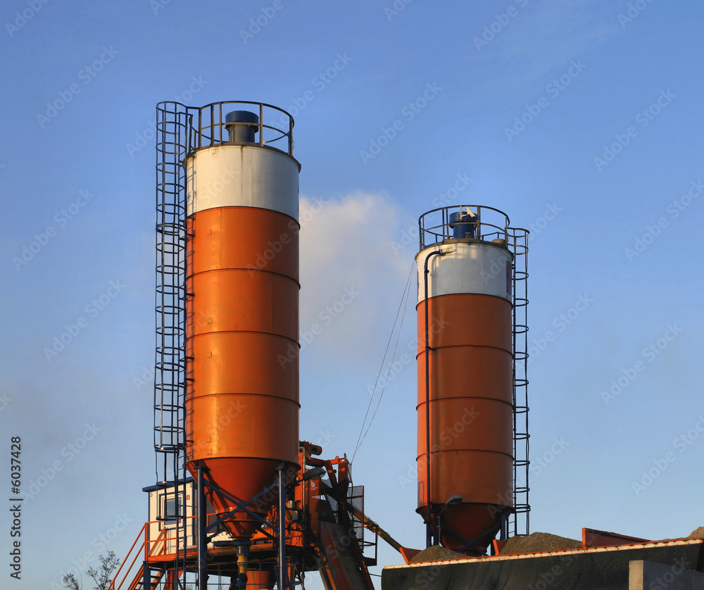 Orange industrial silos and blue sky. Industry.