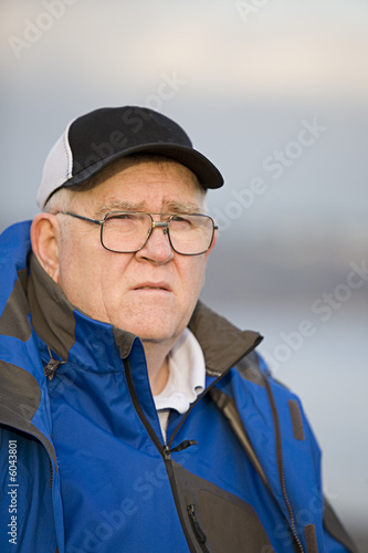 big guy outdoors with pensive look on his face