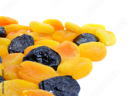 Dried apricot and black plum fruits isolated over white