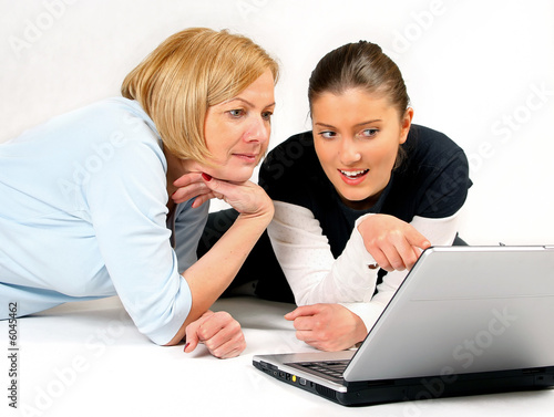 Mother and Daughter Using Laptop over white background