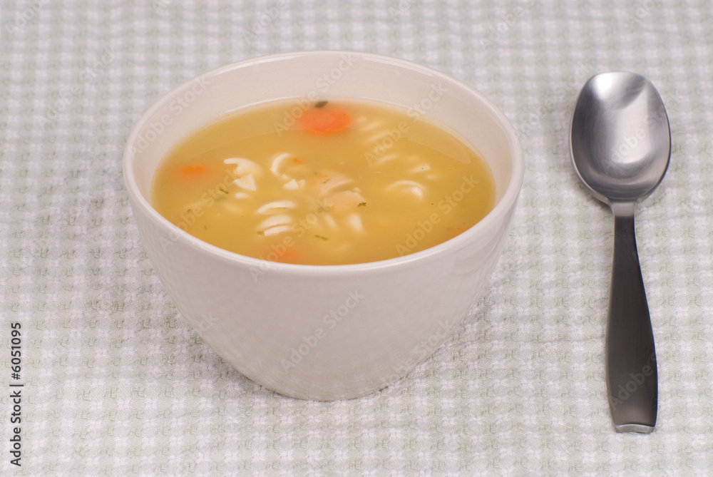 Chicken noodle soup with a spoon and bowl Chicken noodle soup with a spoon and bowl