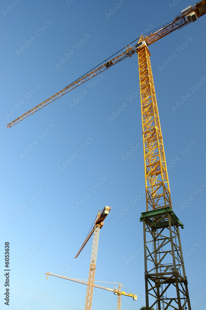Group of jib cranes against clear blue sky Group of jib cranes against clear blue sky