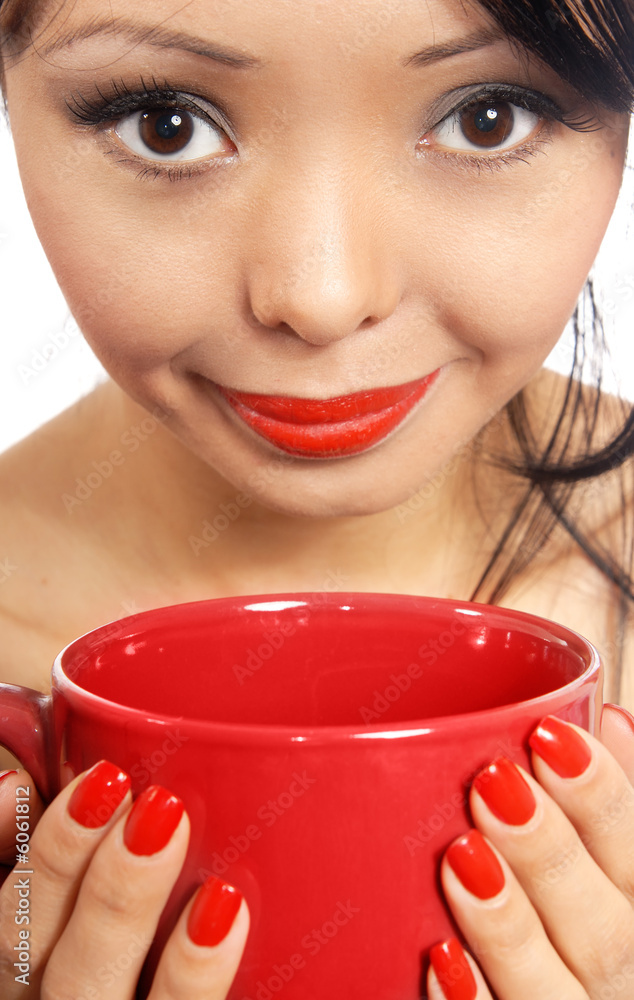 Smiling model holding red cup with drink or eat Smiling model holding red cup with drink or eat