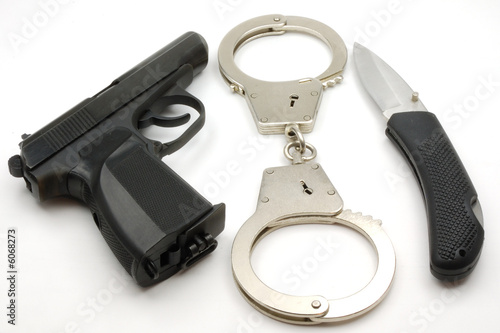 Pistol handcuffs a knife