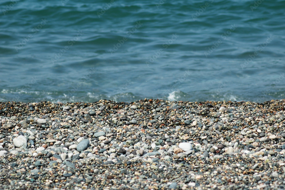 Water and small pebbles at the beach Water and small pebbles at the beach