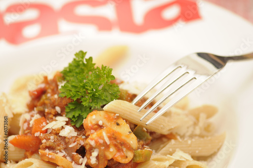 a plate of healthy whole-wheat pasta with bolognese sauce
