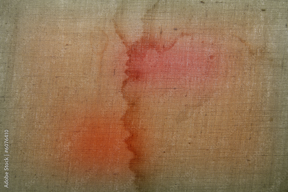 Obraz premium Background from a rough dirty fabric with red spots