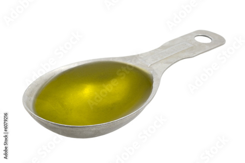 Measuring tablespoon of olive oil isolated on white