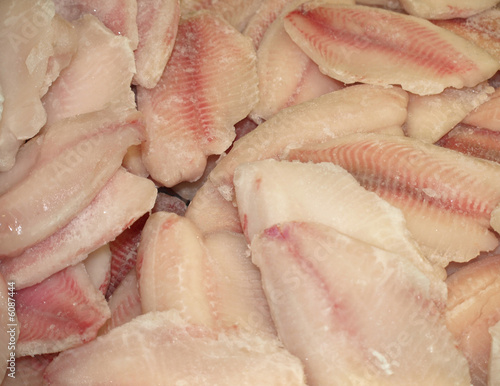 frozen fish fillet on market refrigerator photo