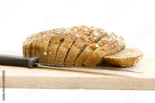 Obraz na plátně Slice brown soad bread on wooden board with knife