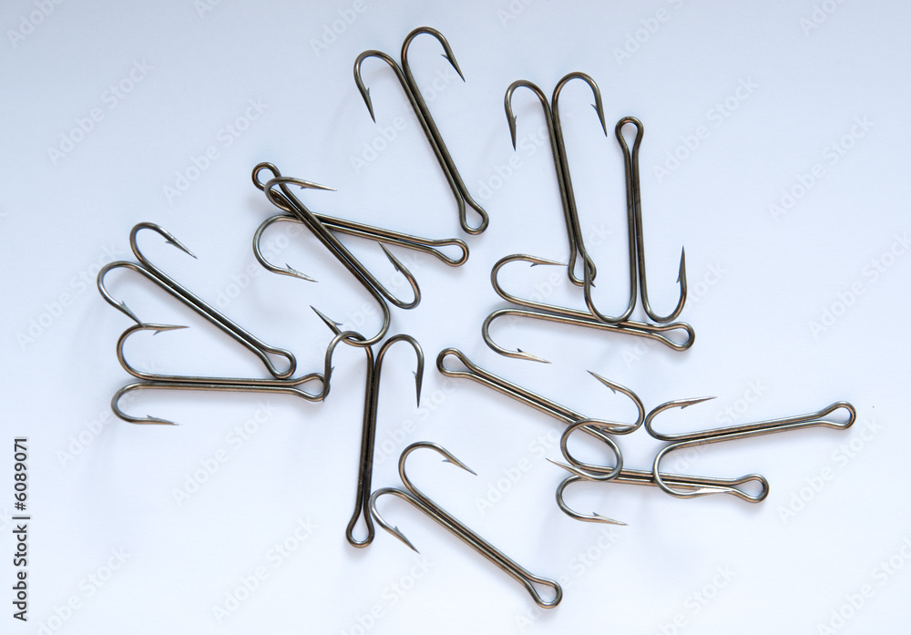 A dosen of fishing hooks on a white background A dosen of fishing hooks on a white background
