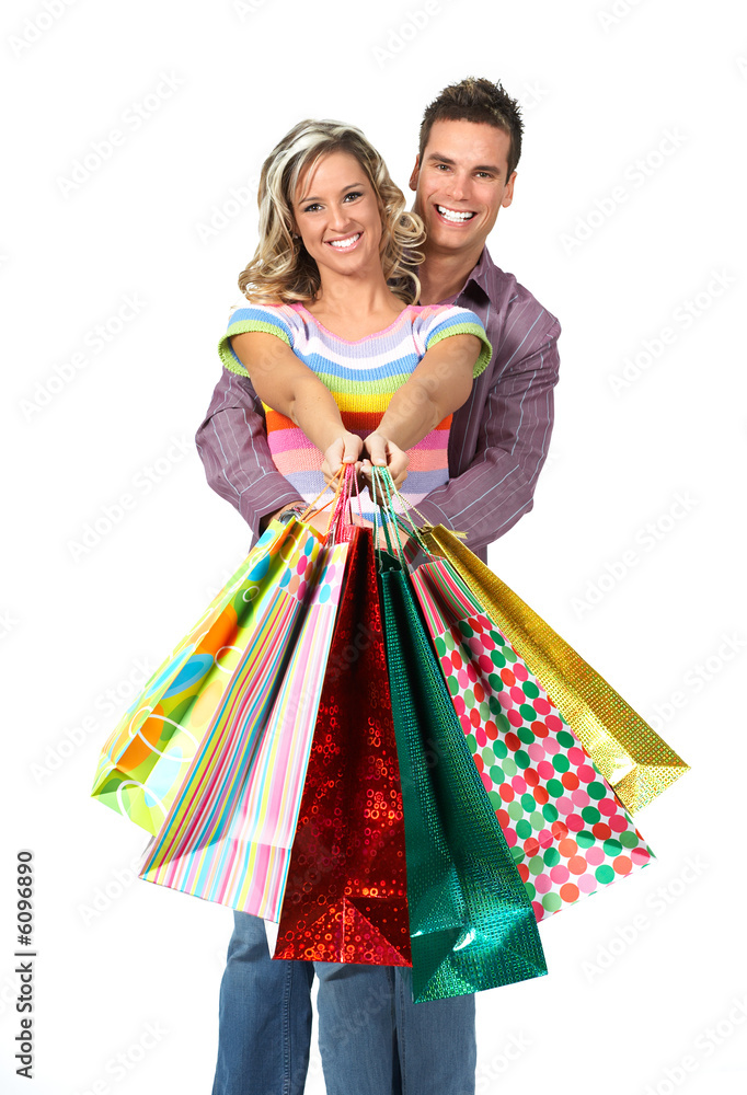 Shopping couple smiling. Isolated over white background. Shopping couple smiling. Isolated over white background.