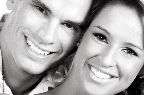 Young love couple smiling. Over white background .