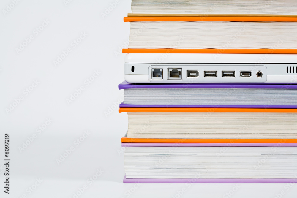 Colorful books with laptop isolated on a white background Colorful books with laptop isolated on a white background