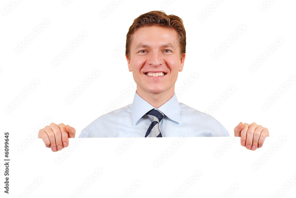 Smiling business man holding a white board