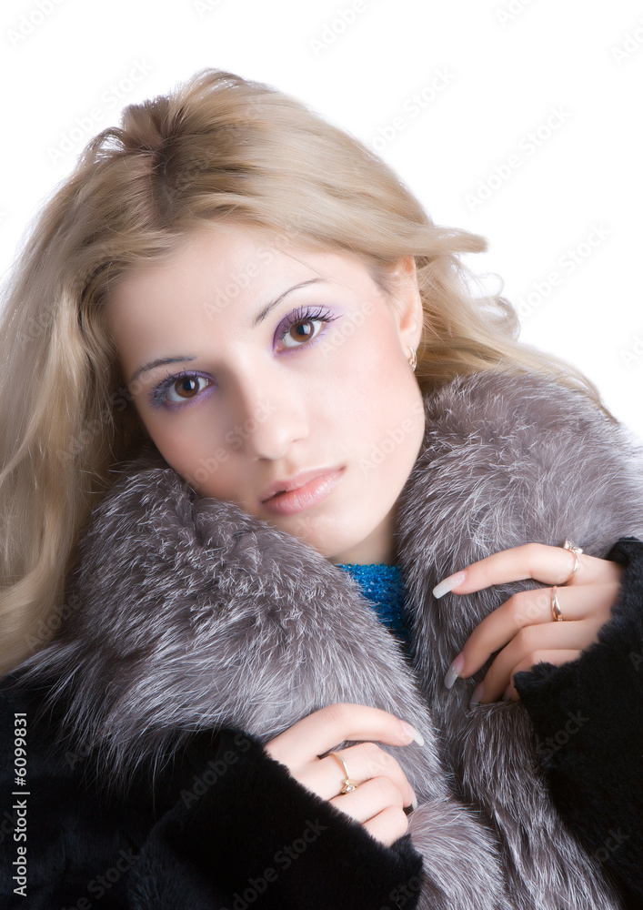 Nice girl in a fur coat isolated on a white background
