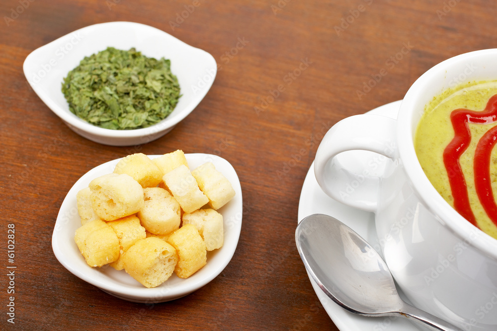 Spinach puree and croutons on wood background. Shallow DOF Spinach puree and croutons on wood background. Shallow DOF