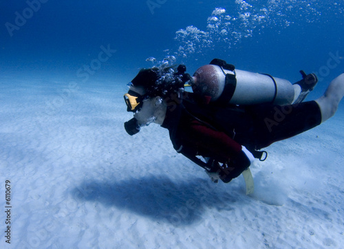 Diver over white sand in the Caribbean Sea