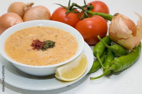 cream soup with vegetables on white background