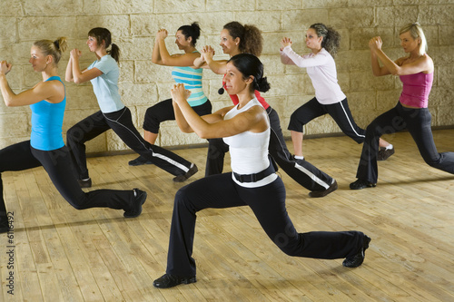 A group of women exercising with fitness instructor 