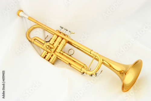 gold lacquer trumpet with mouthpiece on white