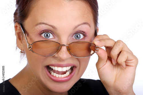 Young angry businesswoman wearing glasses. Isolated over white..