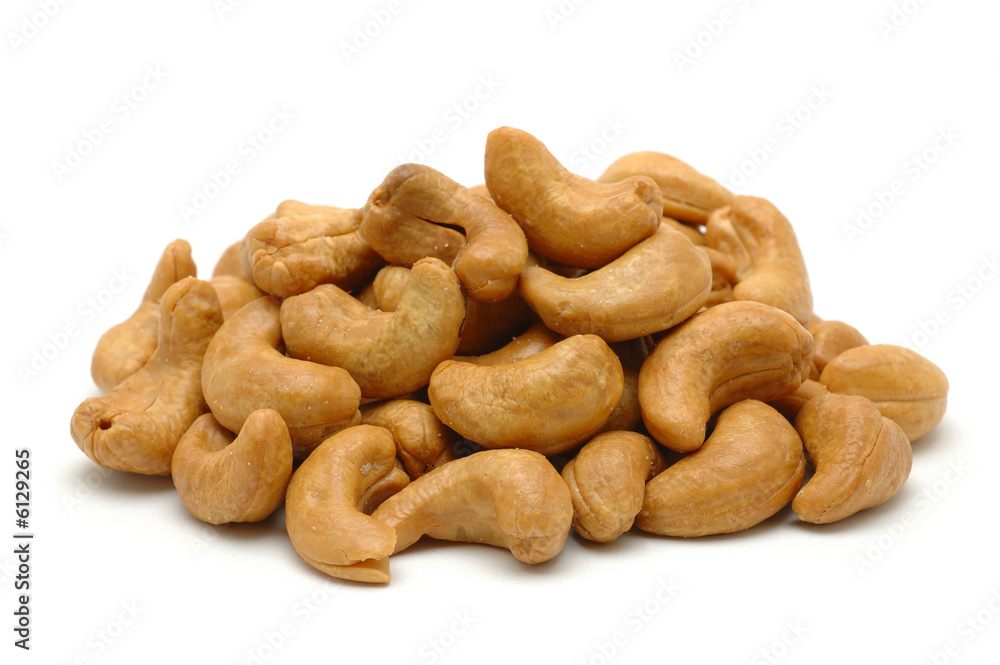 Pile of roasted cashew nuts in isolated white background Pile of roasted cashew nuts in isolated white background