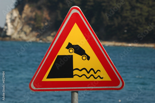 Road sign - car falling into water