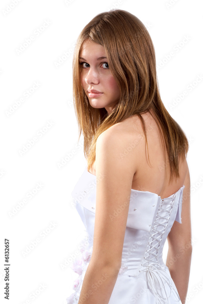 The young beautiful girl in a wedding dress has turned back The young beautiful girl in a wedding dress has turned back