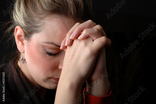 a woman is praying to god with hope