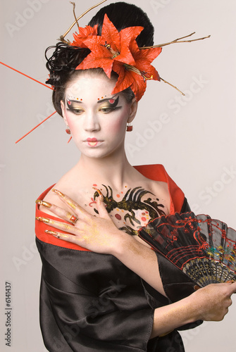 The young Japanese woman on a grey background